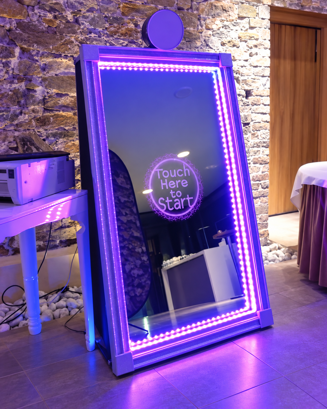 Illuminated mirror photo booth with a Touch Here to Start display
