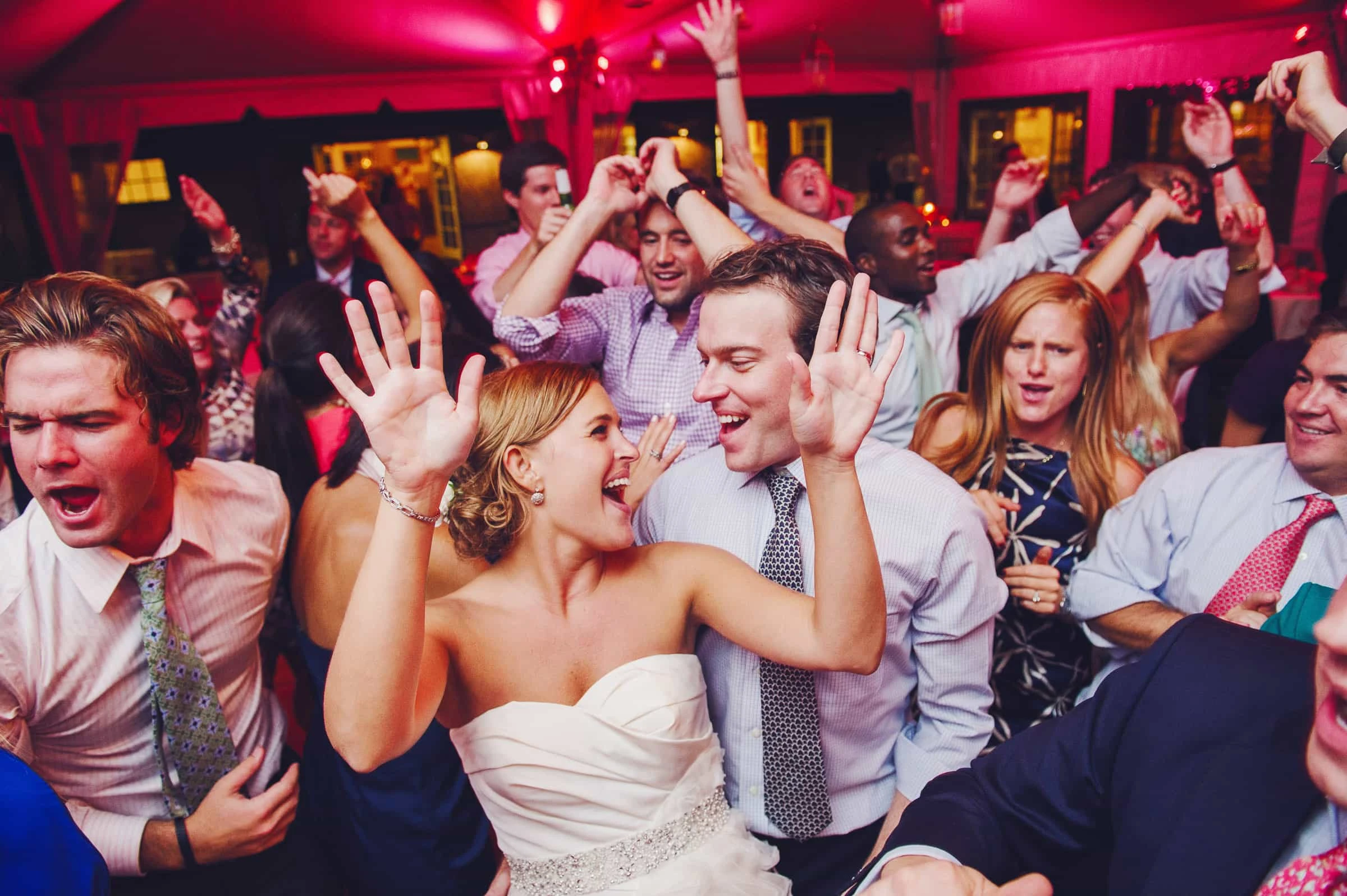 Bride and guests celebrating on a packed dance floor