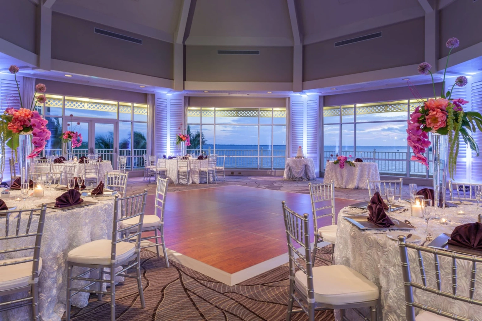Original waterfront reception photograph with blue uplighting.